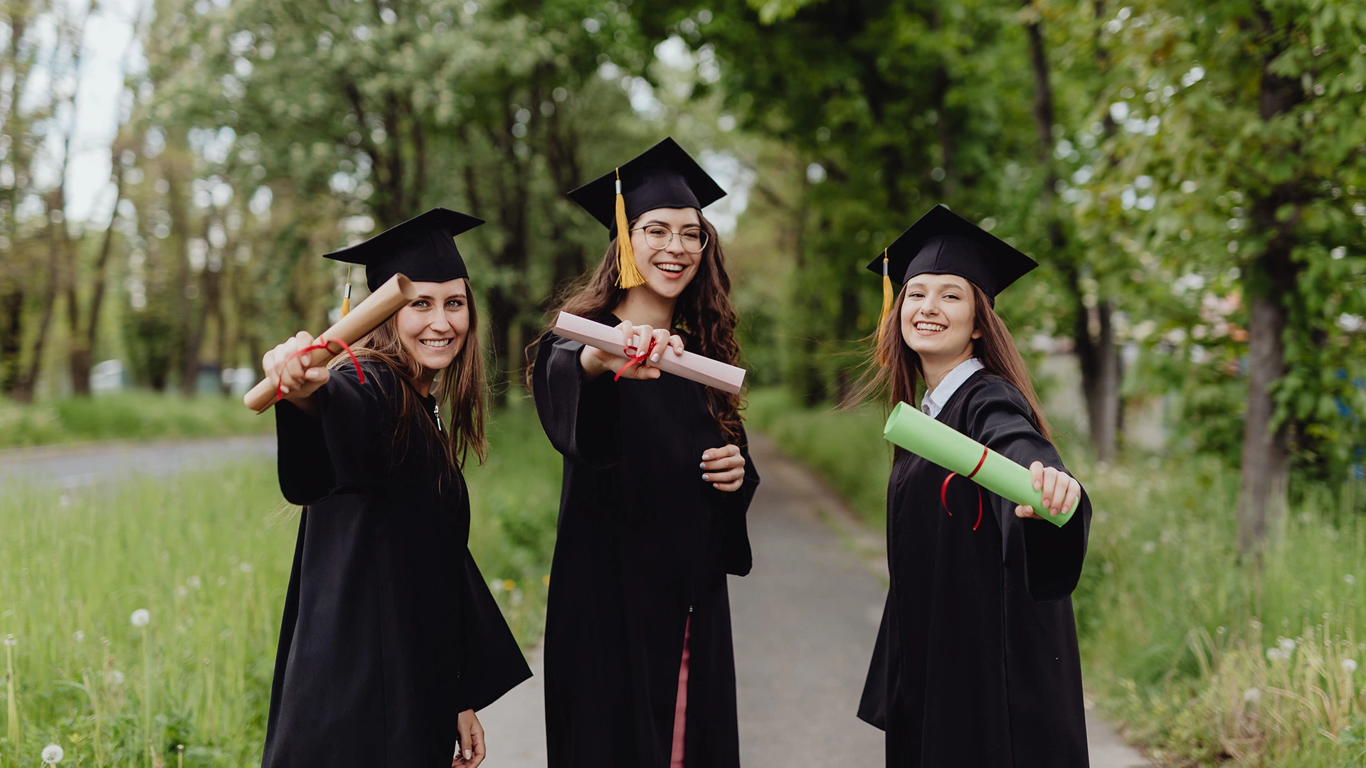 Young women in graduation gowns celebrating