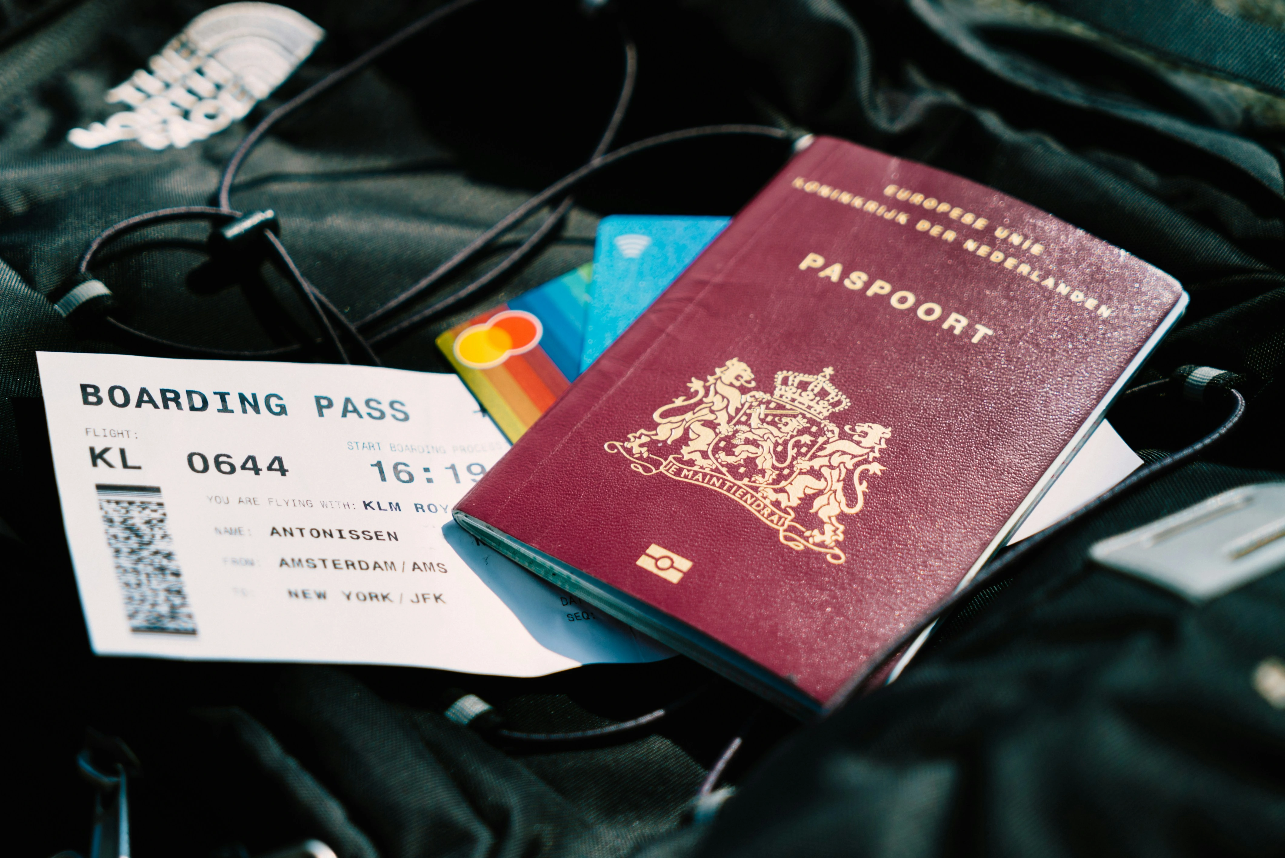 Passport and boarding pass resting on a travel bag, ready for departure