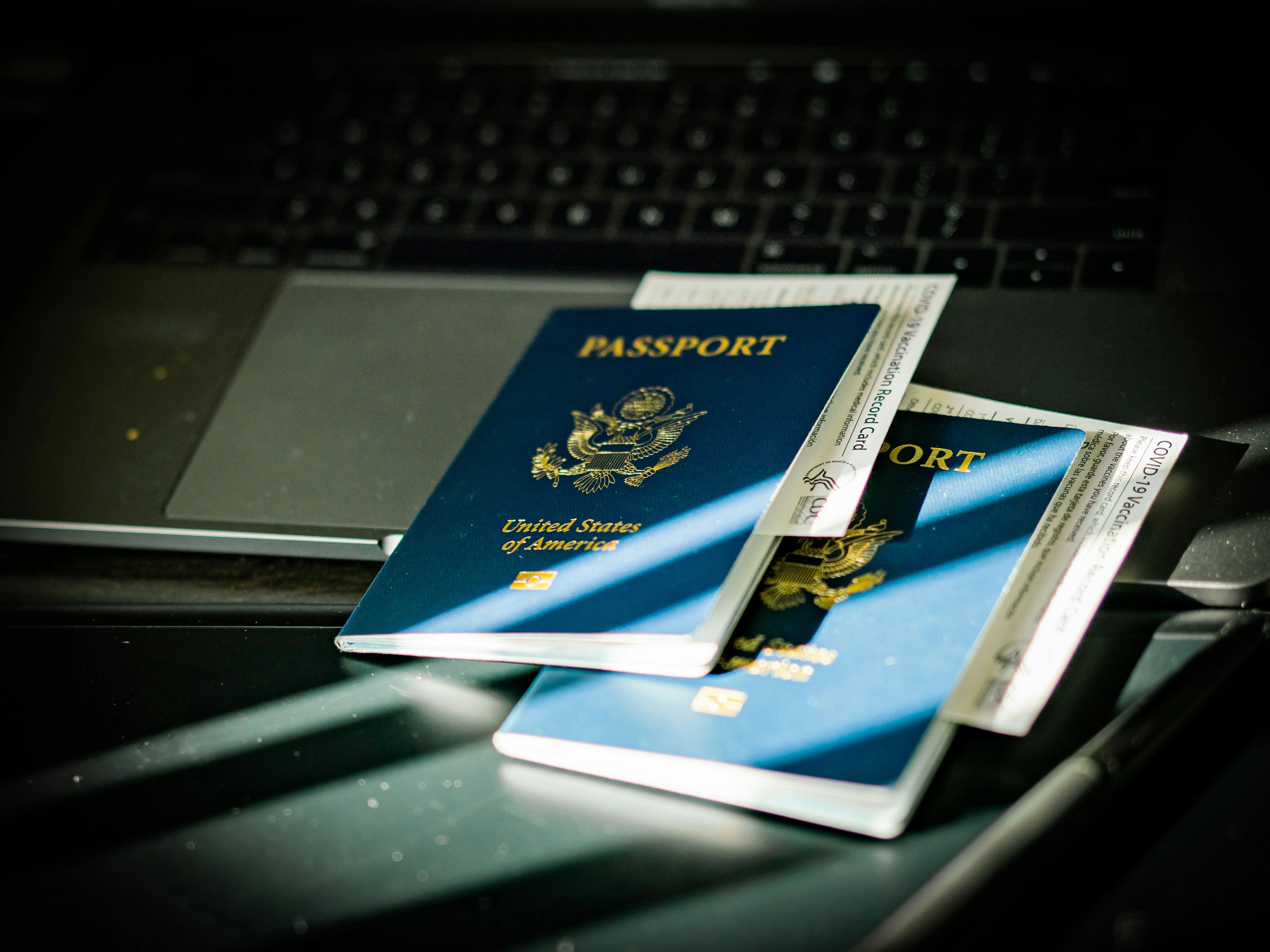 Passport placed on a computer keyboard, representing visa renewal paperwork